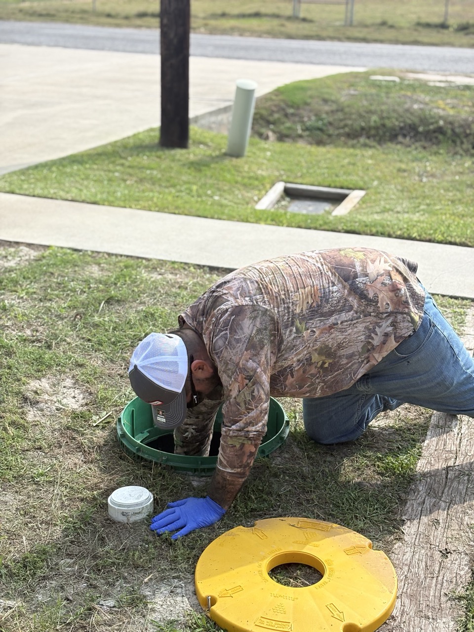Technician pumping a septic tank